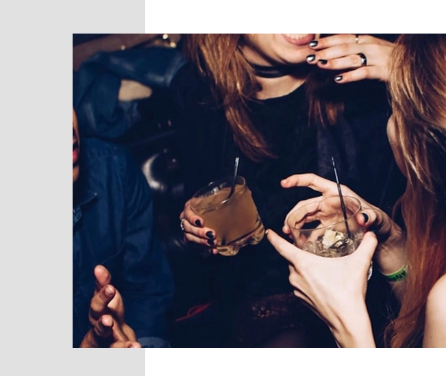 A group of people sitting around drinking and eating.