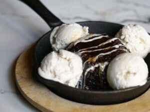A pan of ice cream with chocolate cake in it.
