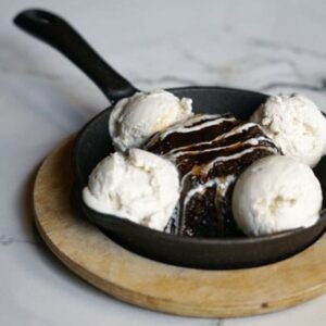 A pan of ice cream with chocolate cake in it.